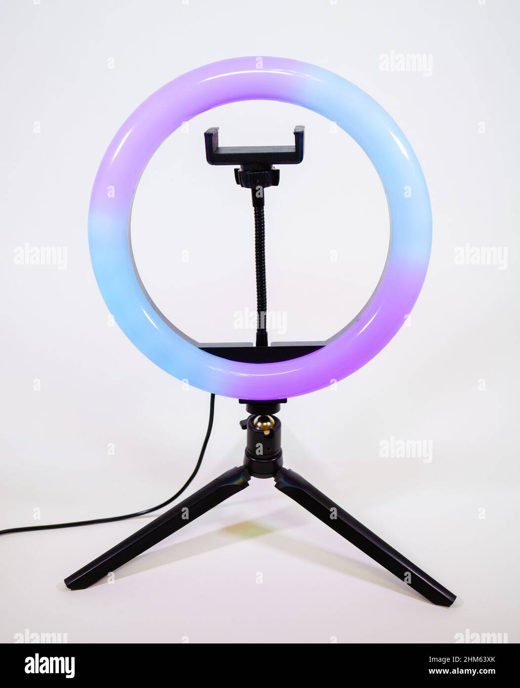 Ring lamp on a small tripod. Purple and blue light. Stock Photo