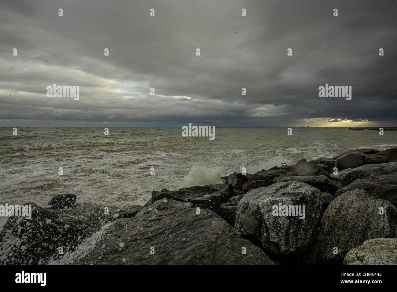 dramatic sky over the black sea with waves, clouds and stones Stock ...