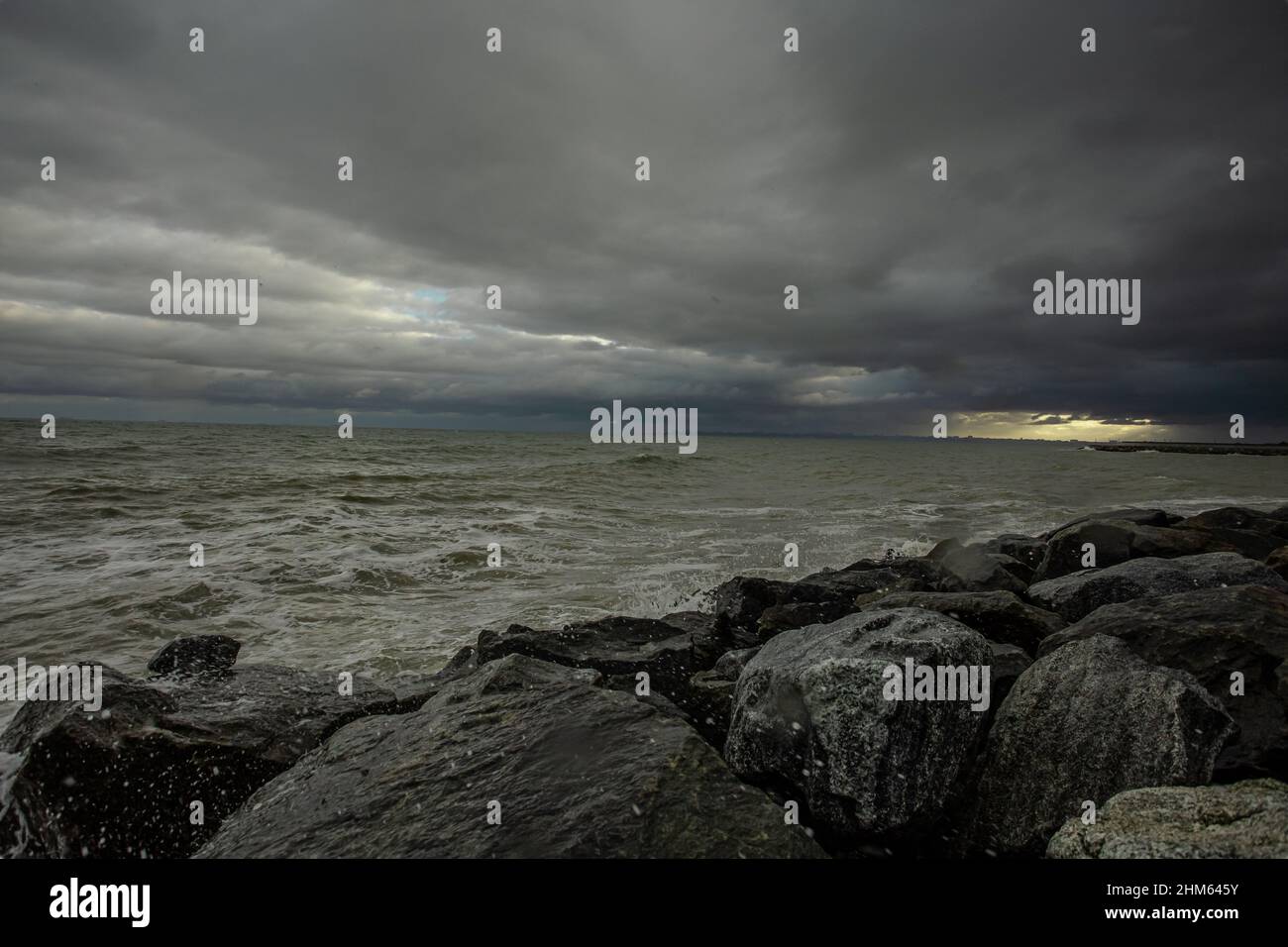 dramatic sky over the black sea with waves, clouds and stones Stock ...