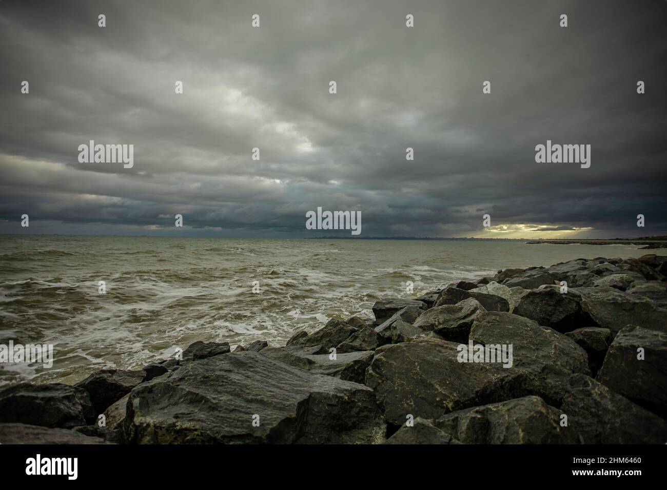 dramatic sky over the black sea with waves, clouds and stones Stock ...