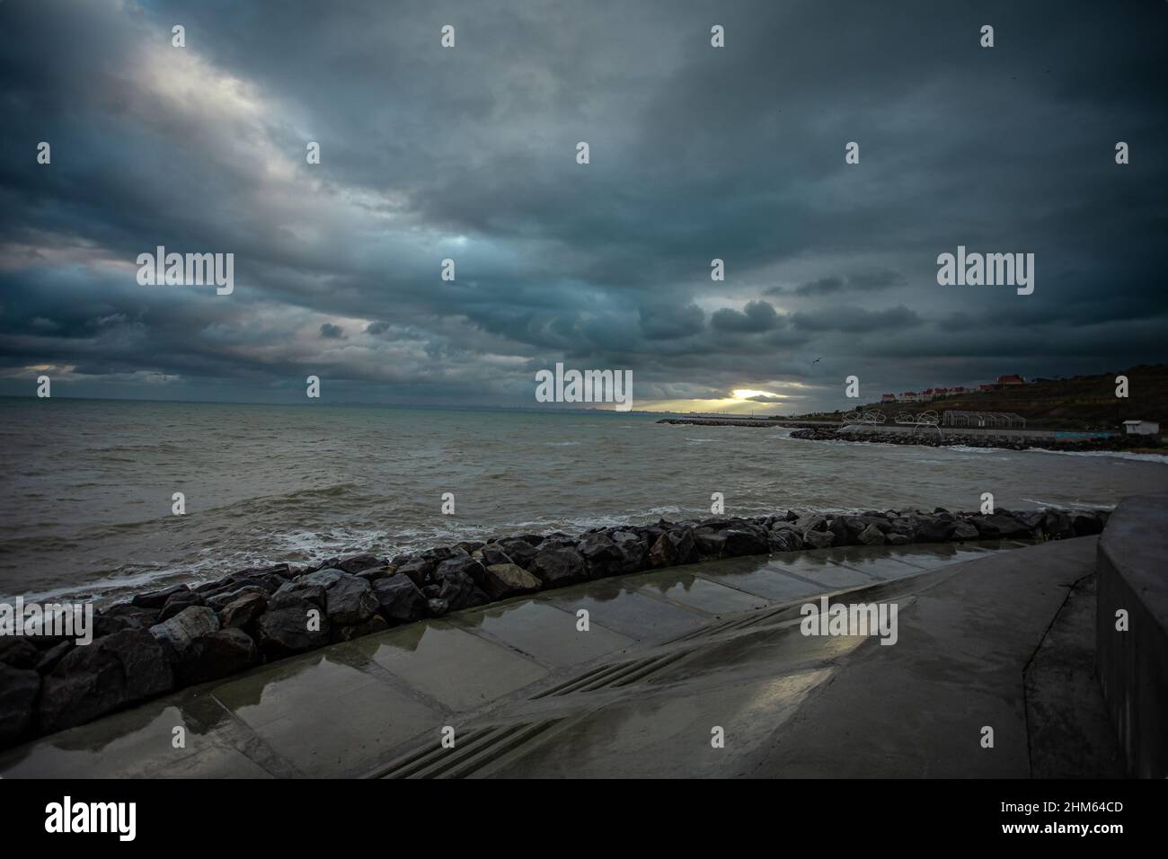 dramatic sky over the black sea with waves, clouds and stones Stock ...