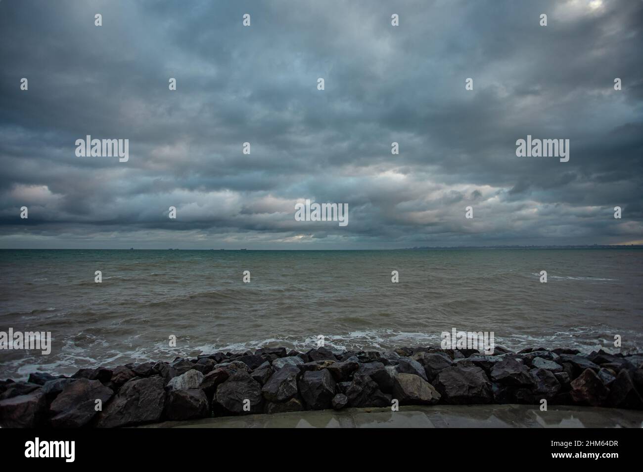 dramatic sky over the black sea with waves, clouds and stones Stock ...