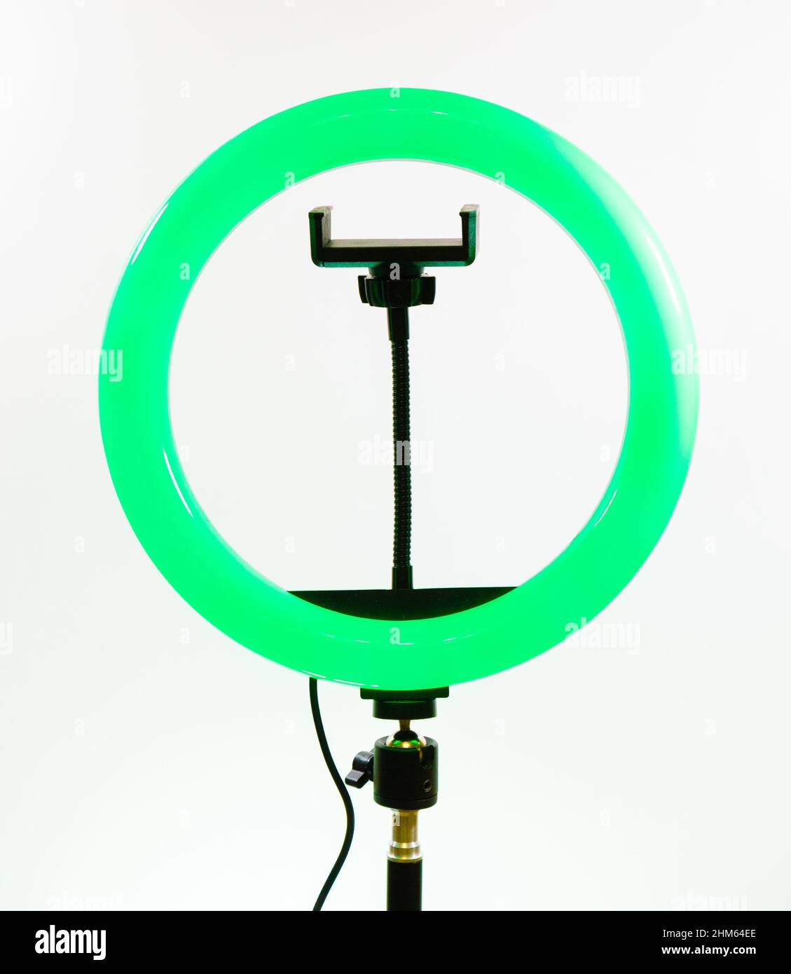 Ring lamp with a smartphone holder. Green light. Stock Photo