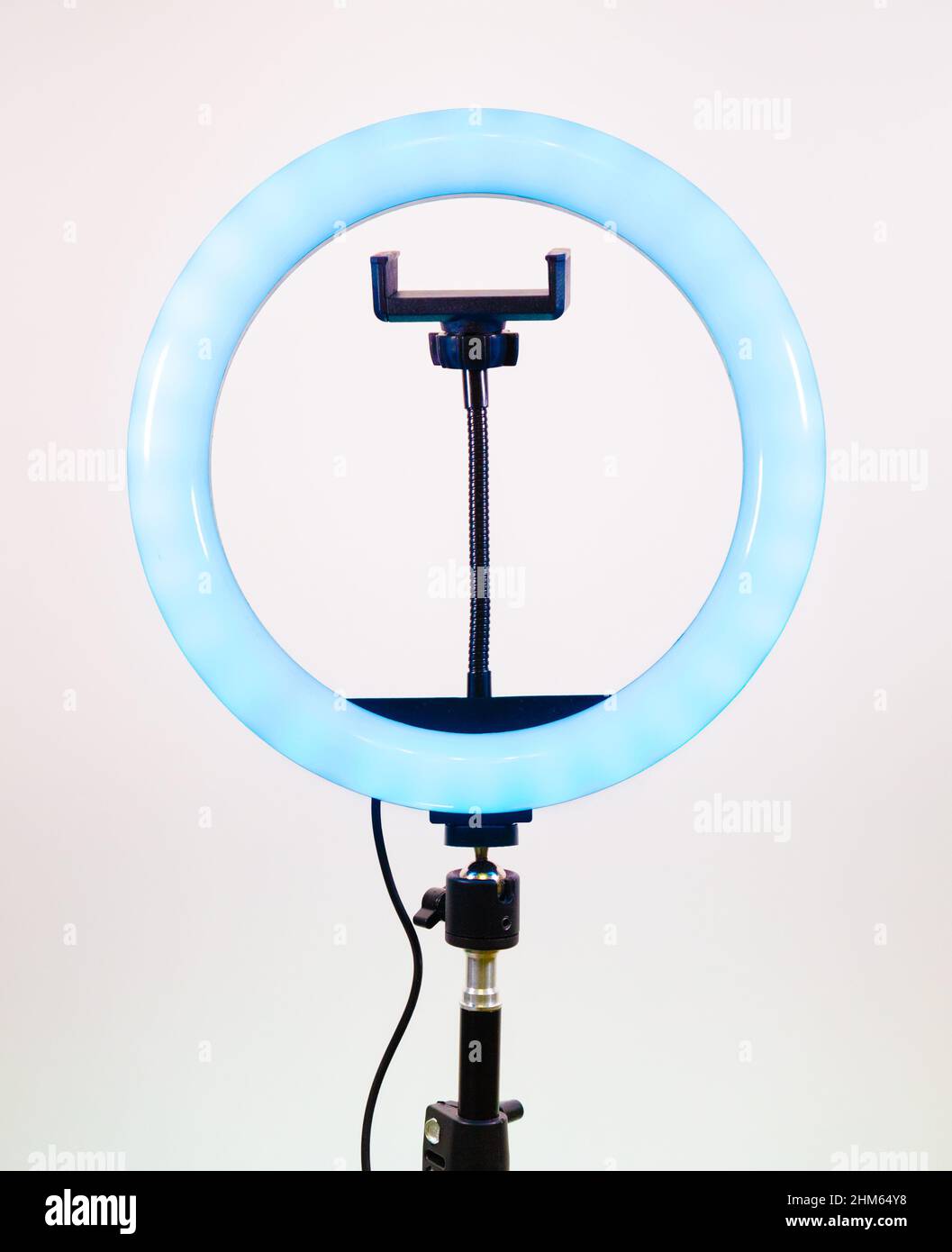 Ring lamp with a smartphone holder. Blue light. Stock Photo