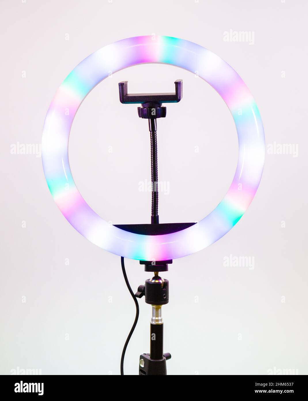 Ring lamp shines in different colors. Magic of light. Stock Photo