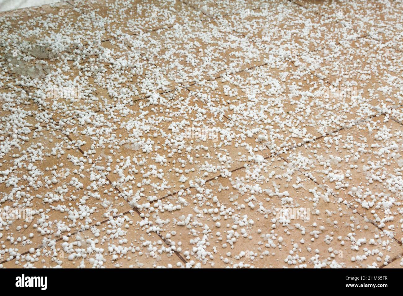 Snow grains on tiles of balcony in winter Stock Photo