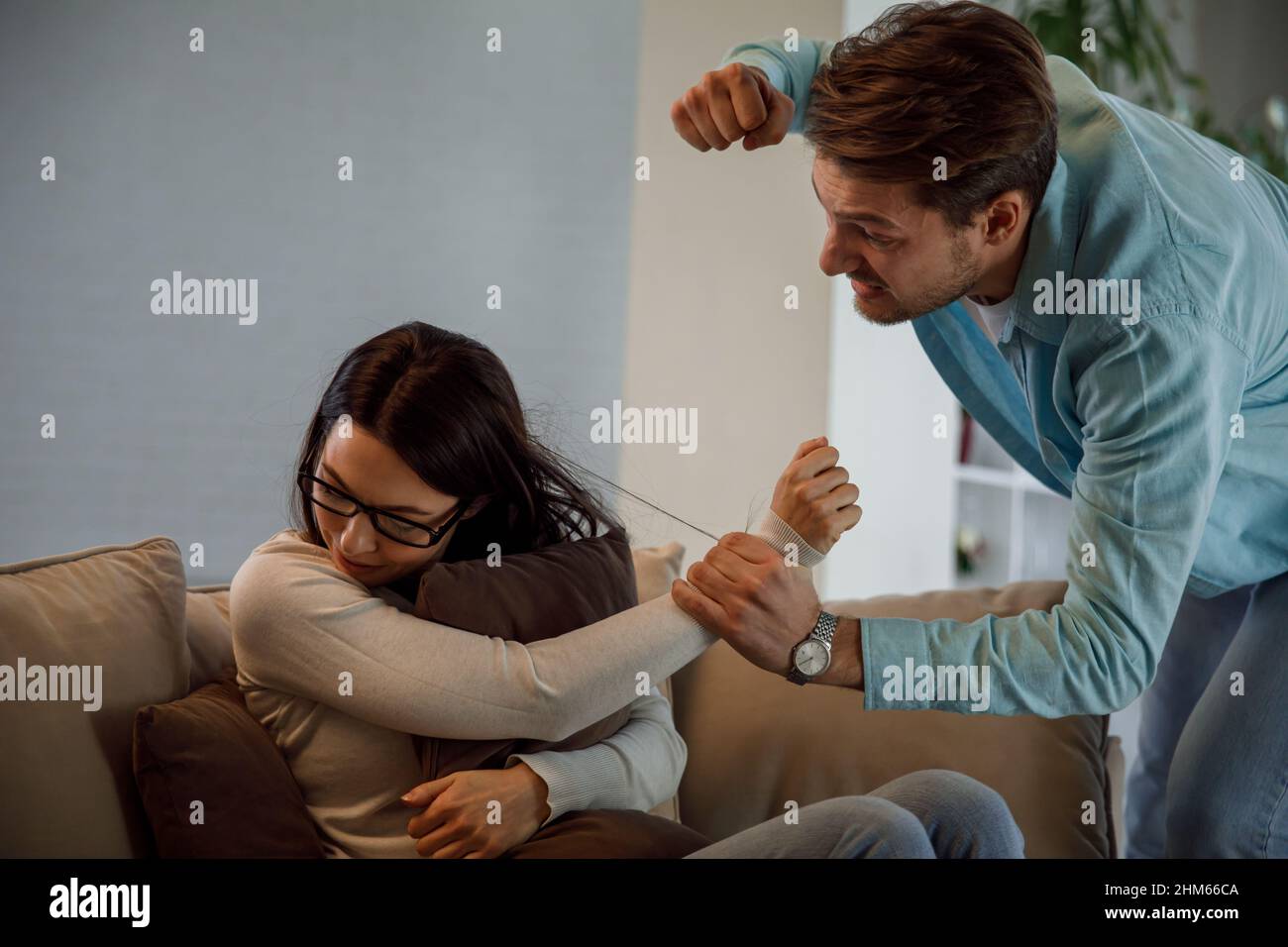 Angry man and woman in fear of domestic abuse Stock Photo