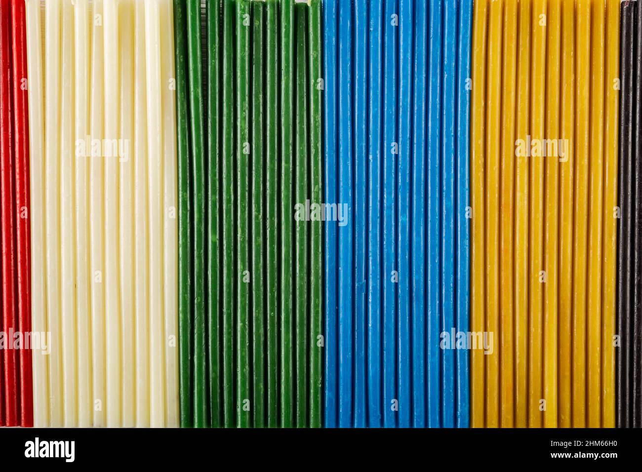 Multicolored background from a set of candles. Bright texture. Stock Photo