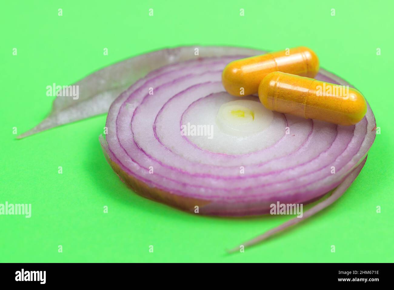 Natural medicine concept, pills on top of onion slice Stock Photo