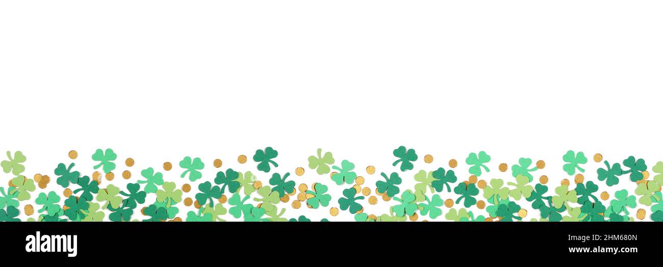 St Patricks Day shamrock and gold coin confetti banner border isolated on a white background with copy space Stock Photo