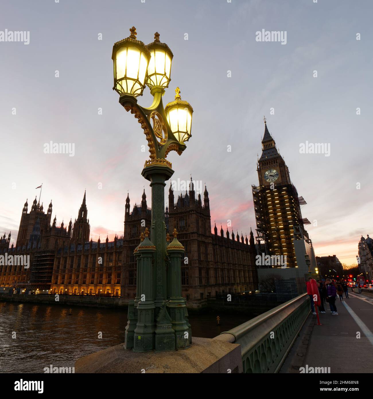 Street Lamp on Westminster Bridge on a winters sunset. Houses of Parliament behind with the Elizabeth Tower housing Big Ben. Stock Photo