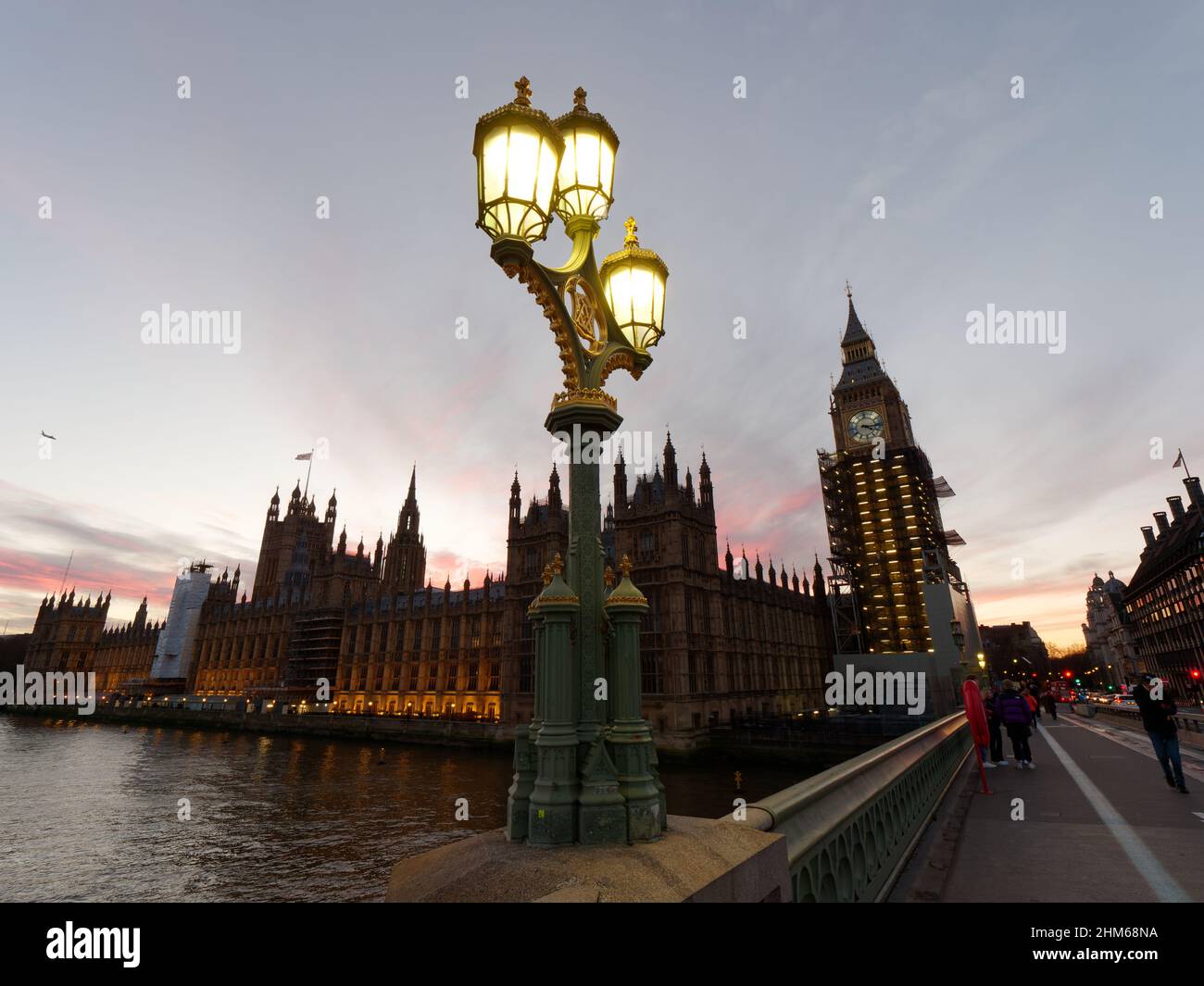 Street Lamp on Westminster Bridge on a winters sunset. Houses of Parliament behind with the Elizabeth Tower housing Big Ben. Stock Photo