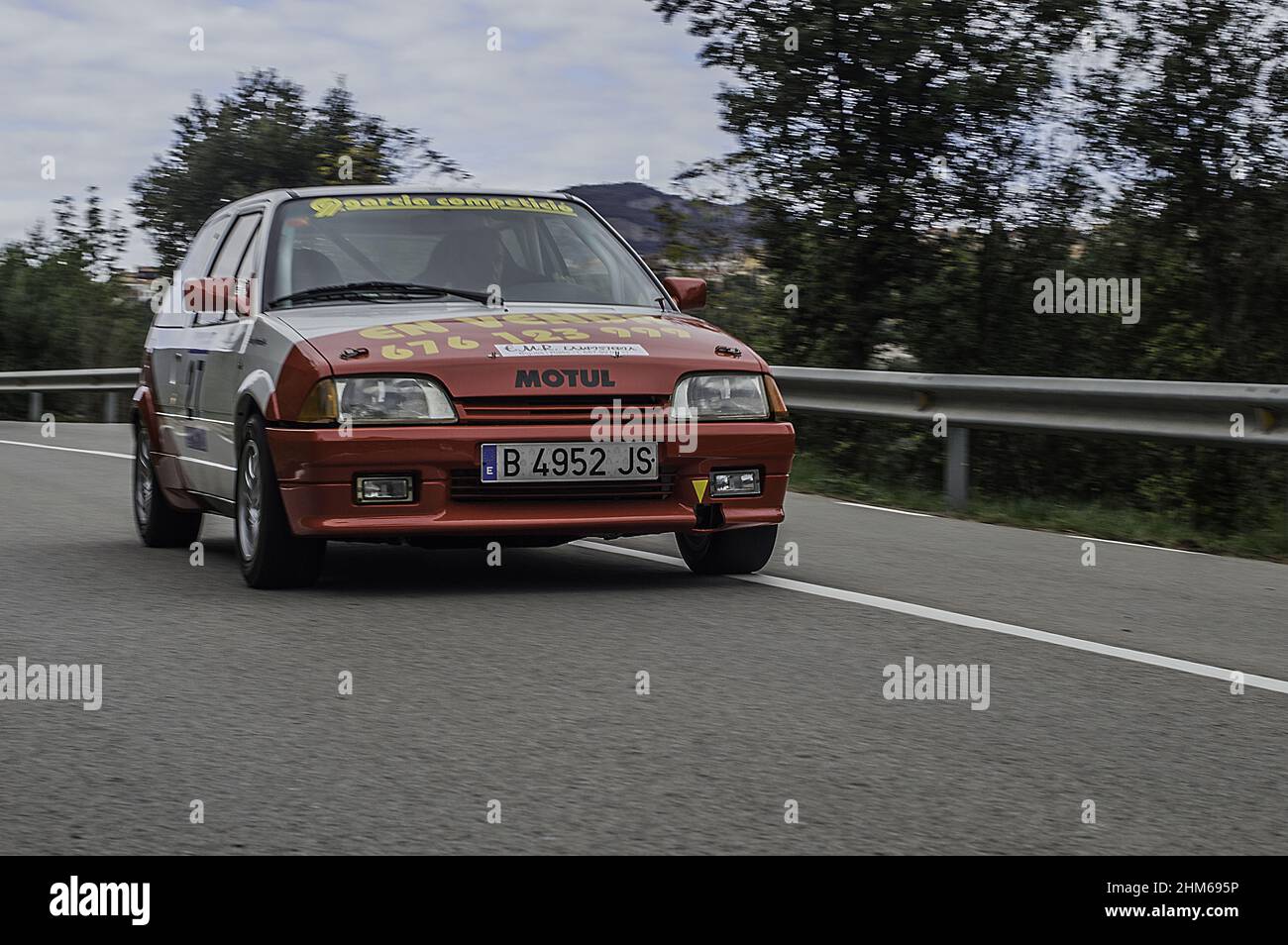 Red Citroen Ax racing on the asphalt rally at full speed Stock Photo
