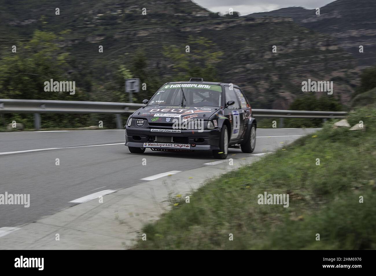 Gray Citroen Ax racing on the asphalt rally at full speed Stock Photo