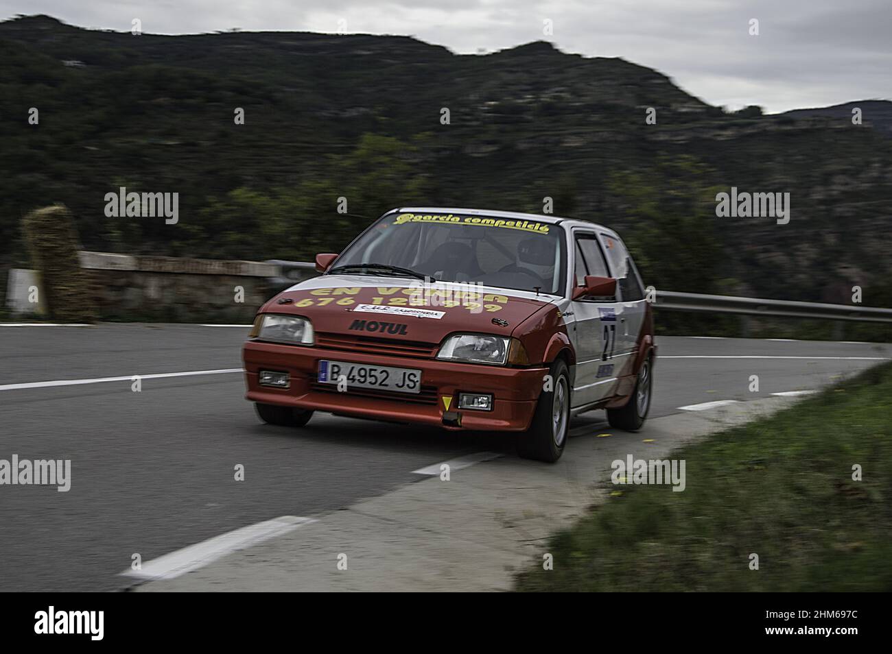 A red Citroen Ax racing on the asphalt rally at full speed Stock Photo