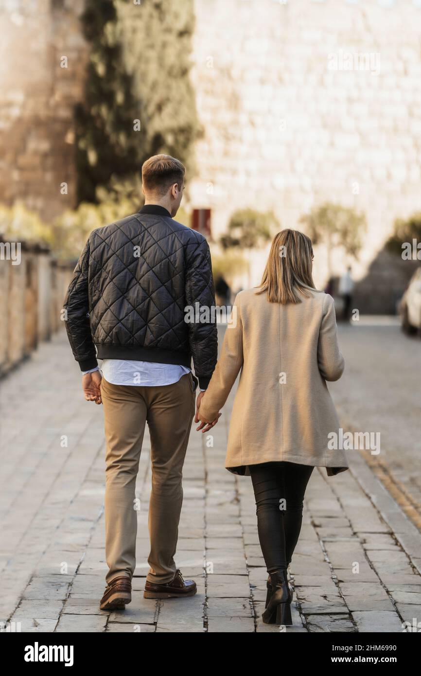 Couple walking hand in hand hi-res stock photography and images - Alamy
