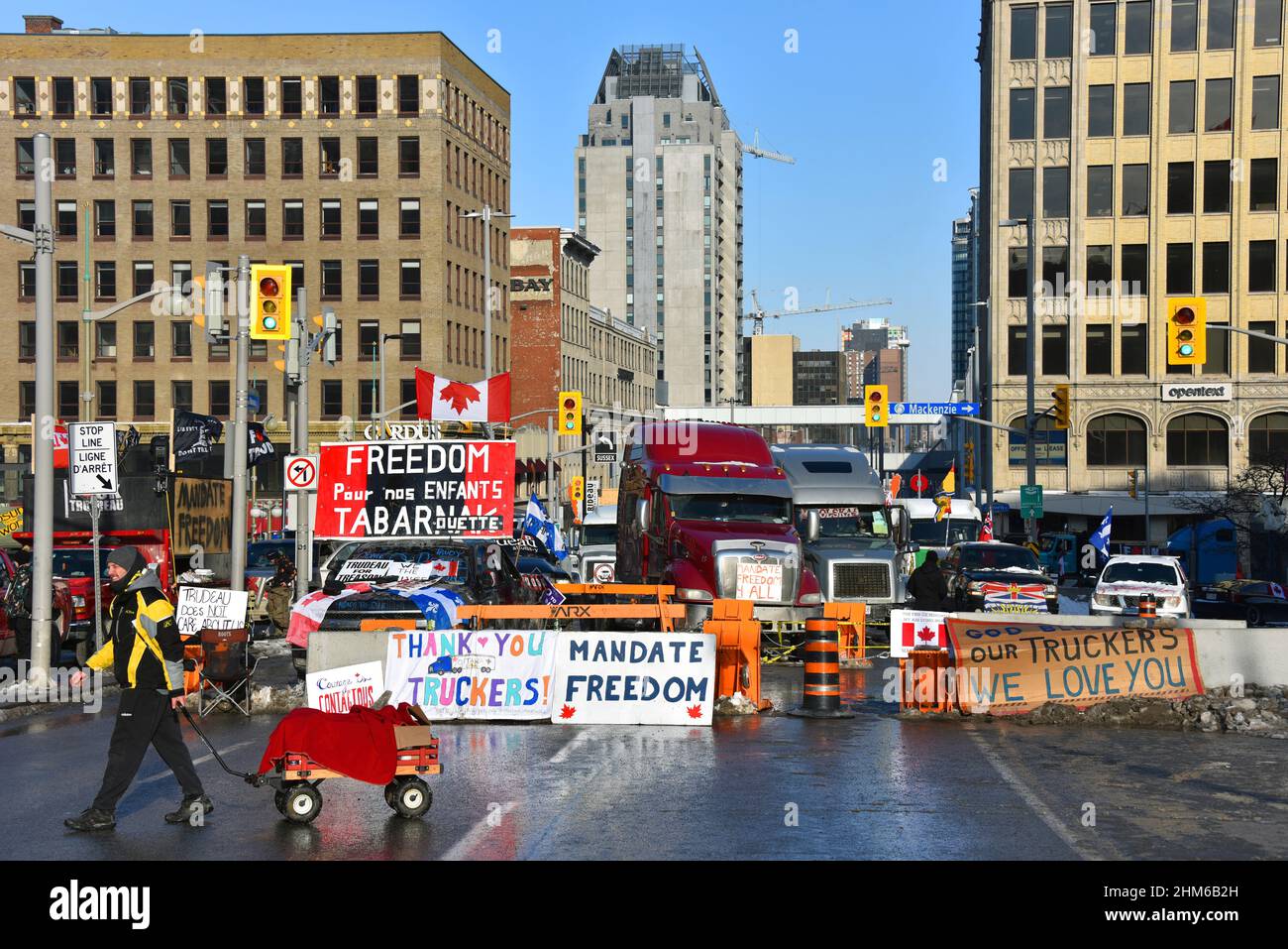 Ottawa, Canada – February 7, 2022: Convoy trucks provide block between Wellington and Rideau streets, a main transit thoroughfare, as part of the trucker convoy protest. The protest has shutdown much of downtown Ottawa and caused a lot of grief for local residents and business. Stock Photo