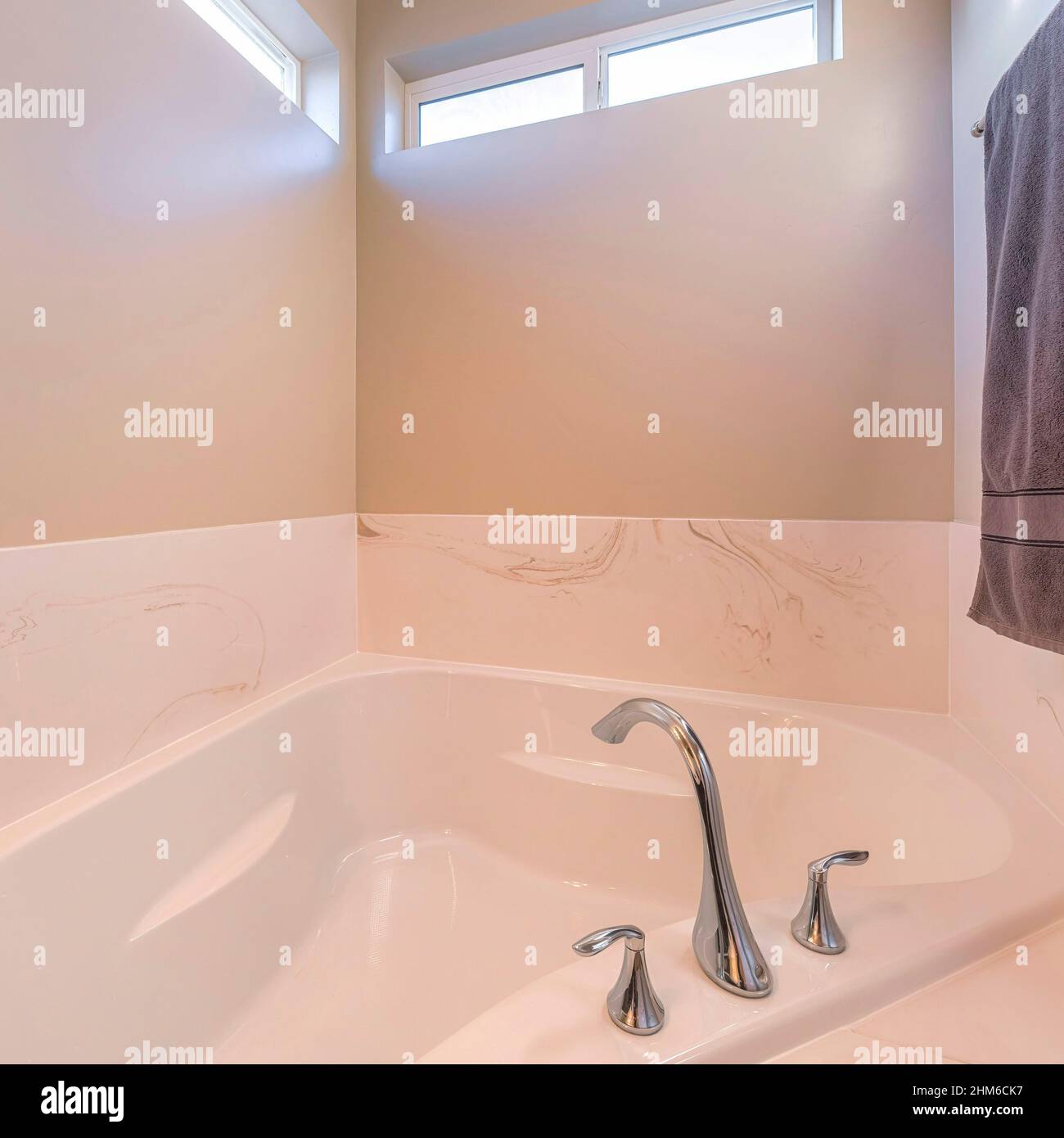 Square Alcove bathtub with widespread stainless steel faucet Stock ...