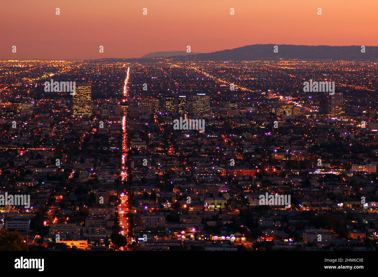 The lights of Los Angeles glow under a sunset sky Stock Photo Alamy