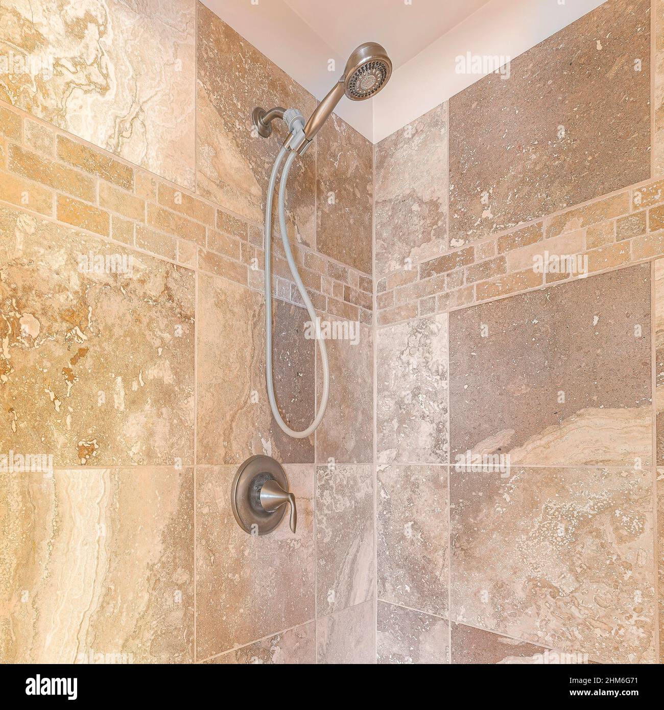 Square Interior of a shower stall with brown marble tiles wall Stock