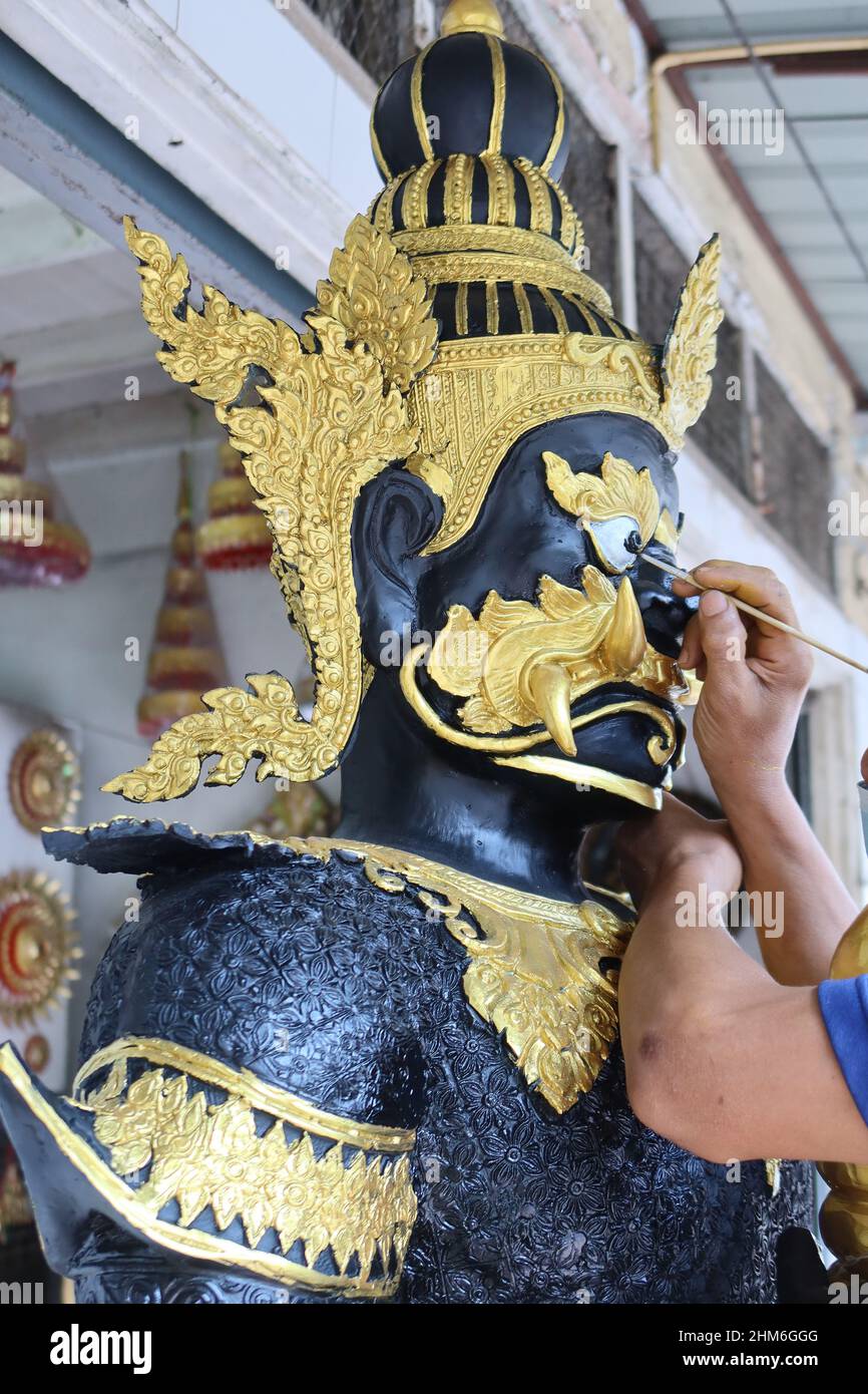 Artist puts final touch on a  statue in Bamrung Muang Road, Bangkok, Thailand Stock Photo