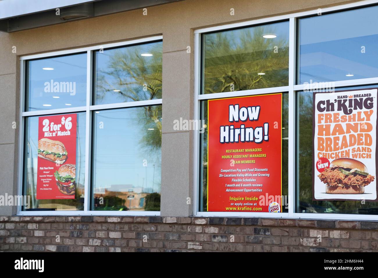 A Now Hiring sign advertising different positions available is