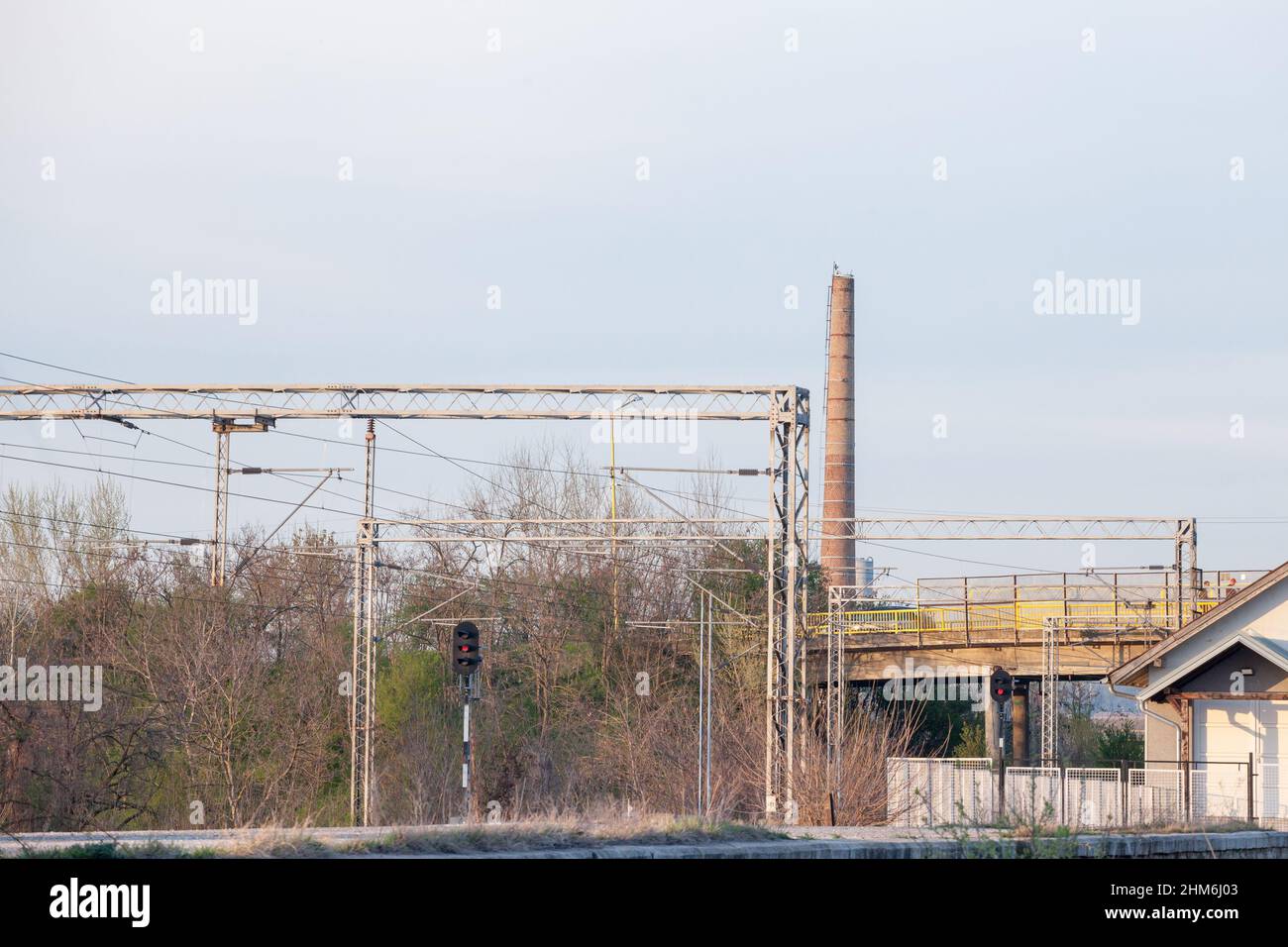 Picture of an electrified railway line, with power cables, train