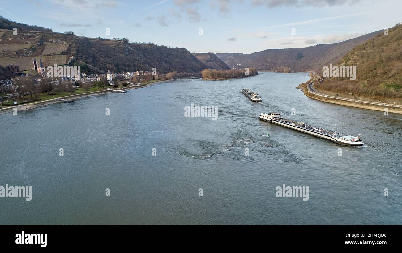 Bacharach, Germany. 28th Jan, 2022. Cargo ships pass the town of Bacharach on the Rhine. The authorities are planning to deepen the Rhine so that the ships can transport more freight even at low water. (to dppa-KORR 'Is the island romance disappearing? - Criticism of Rhine deepening') Credit: Thomas Frey/dpa/Alamy Live News Stock Photo