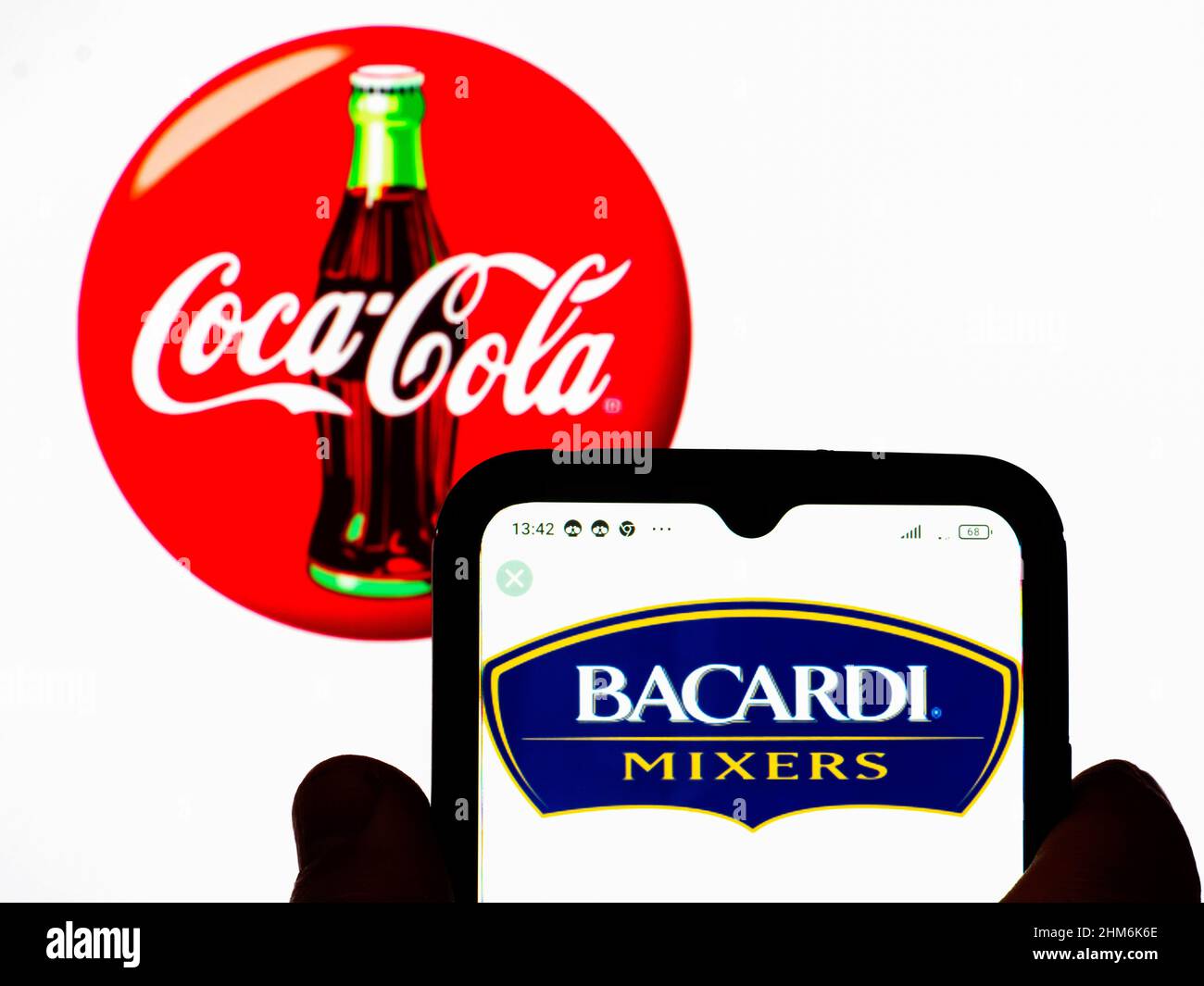 Ukraine. 07th Feb, 2022. In this photo illustration, the Bacardi Mixers, a co-branded product with the Bacardi rum manufacture logo is displayed on a smartphone screen with a Coca-Cola Company logo in the background. Credit: SOPA Images Limited/Alamy Live News Stock Photo