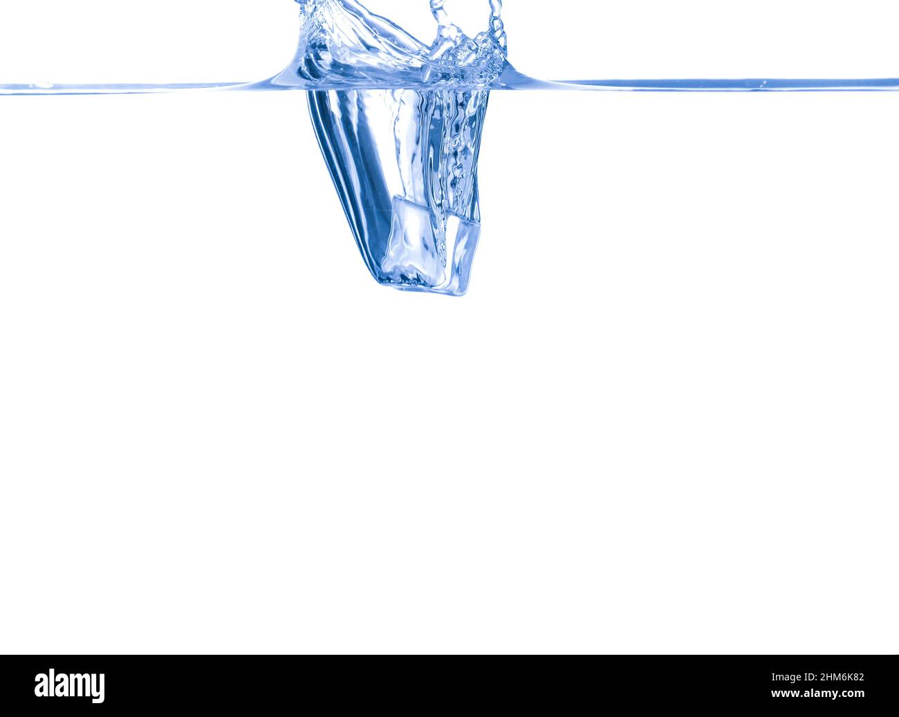 Falling of ice cube into clean water on white background Stock Photo ...