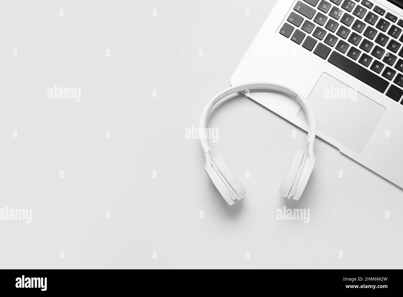 Modern laptop and headphones on white background Stock Photo - Alamy
