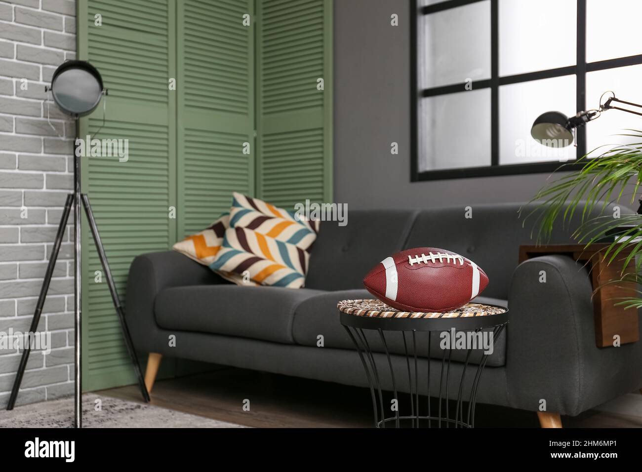 Rugby ball in interior of modern living room Stock Photo