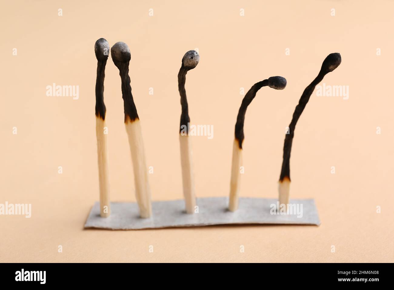 Burnt matches on beige background. Concept of emotional burnout Stock ...