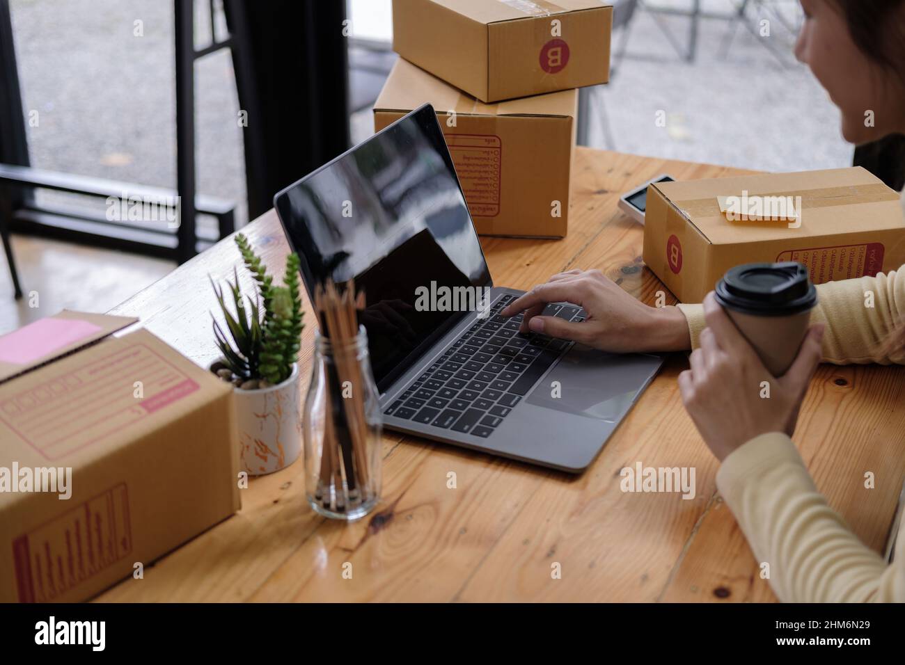 Small business aspiring entrepreneur, small and medium business freelance working in home office using computer, online marketing packaging box Stock Photo