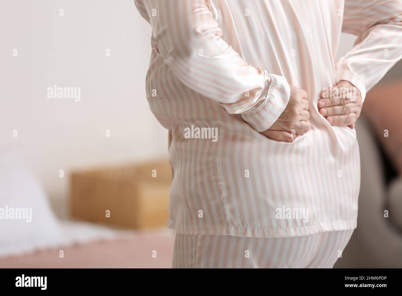 Senior woman suffering from back pain in bedroom, closeup Stock Photo ...