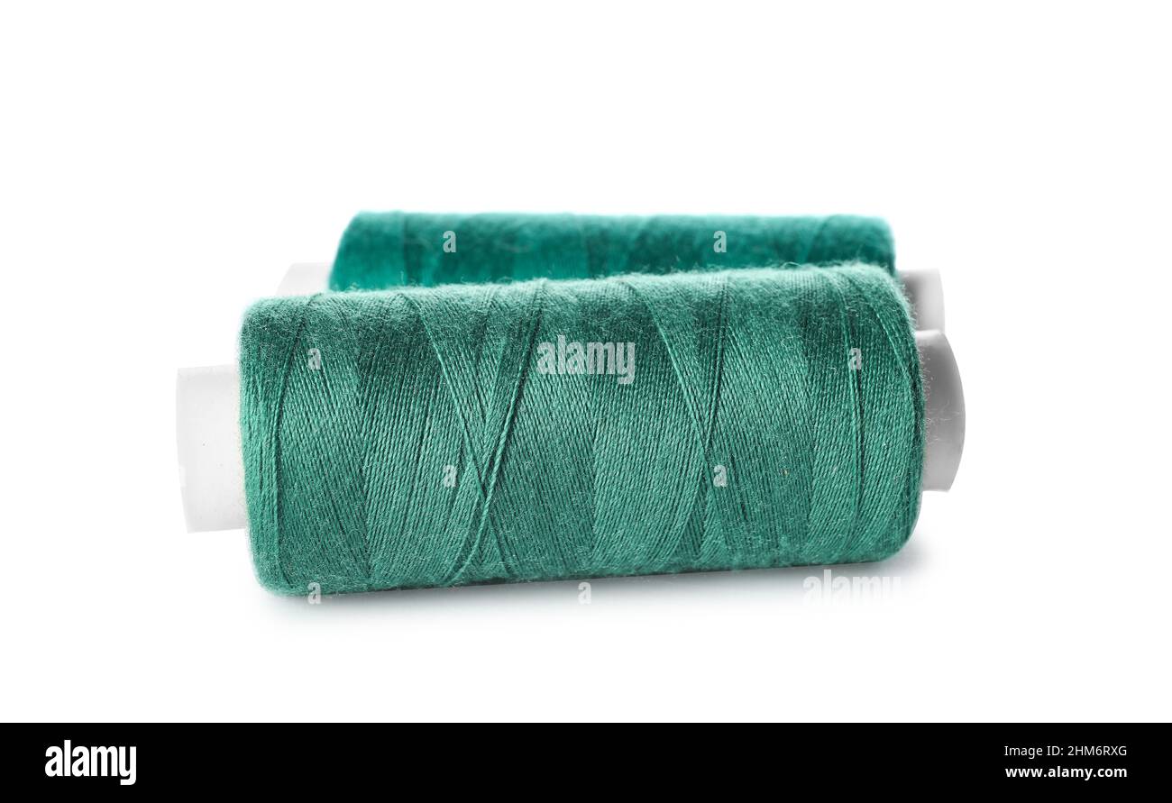 Green sewing threads on white background Stock Photo Alamy