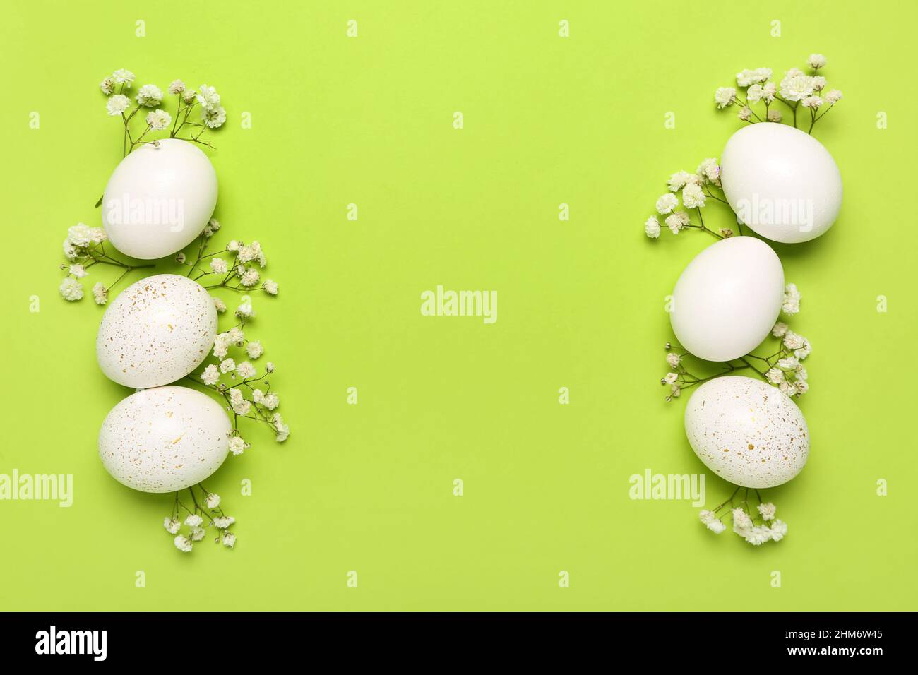 Composition with beautiful Easter eggs and gypsophila flowers on green ...