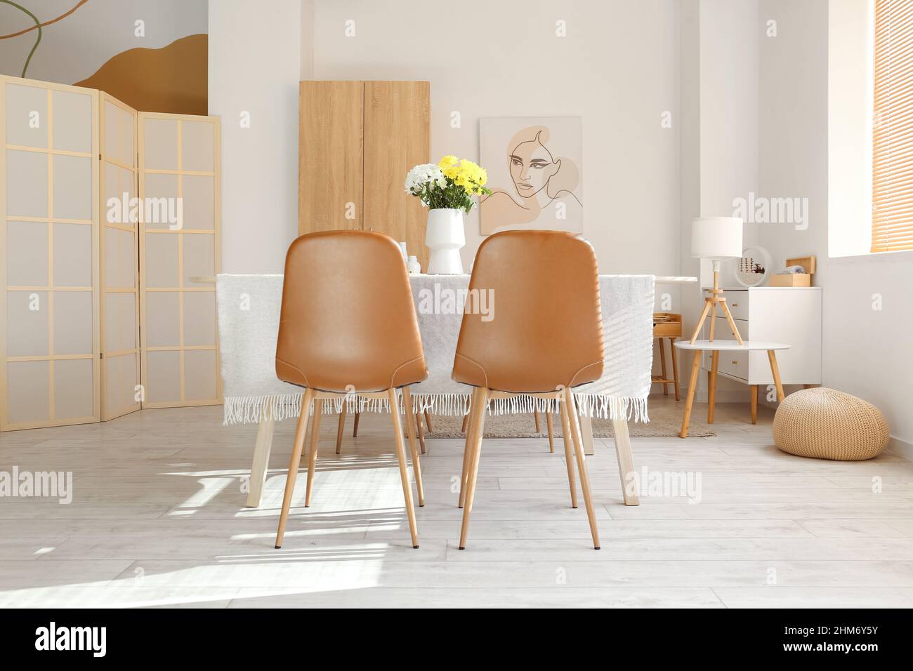 Interior of stylish room with dining table served for International ...