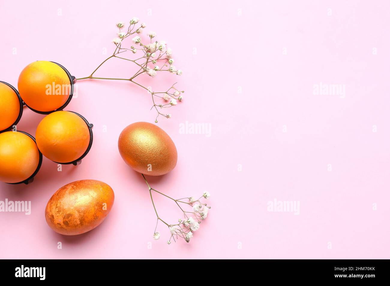 Composition with beautiful Easter eggs and gypsophila flowers on pink ...