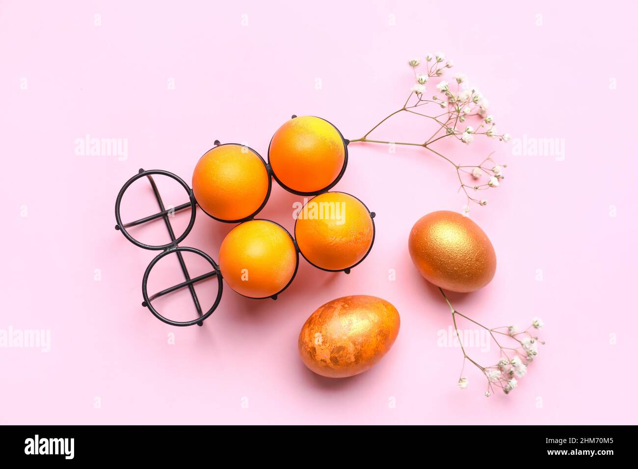 Composition with beautiful Easter eggs and gypsophila flowers on pink ...
