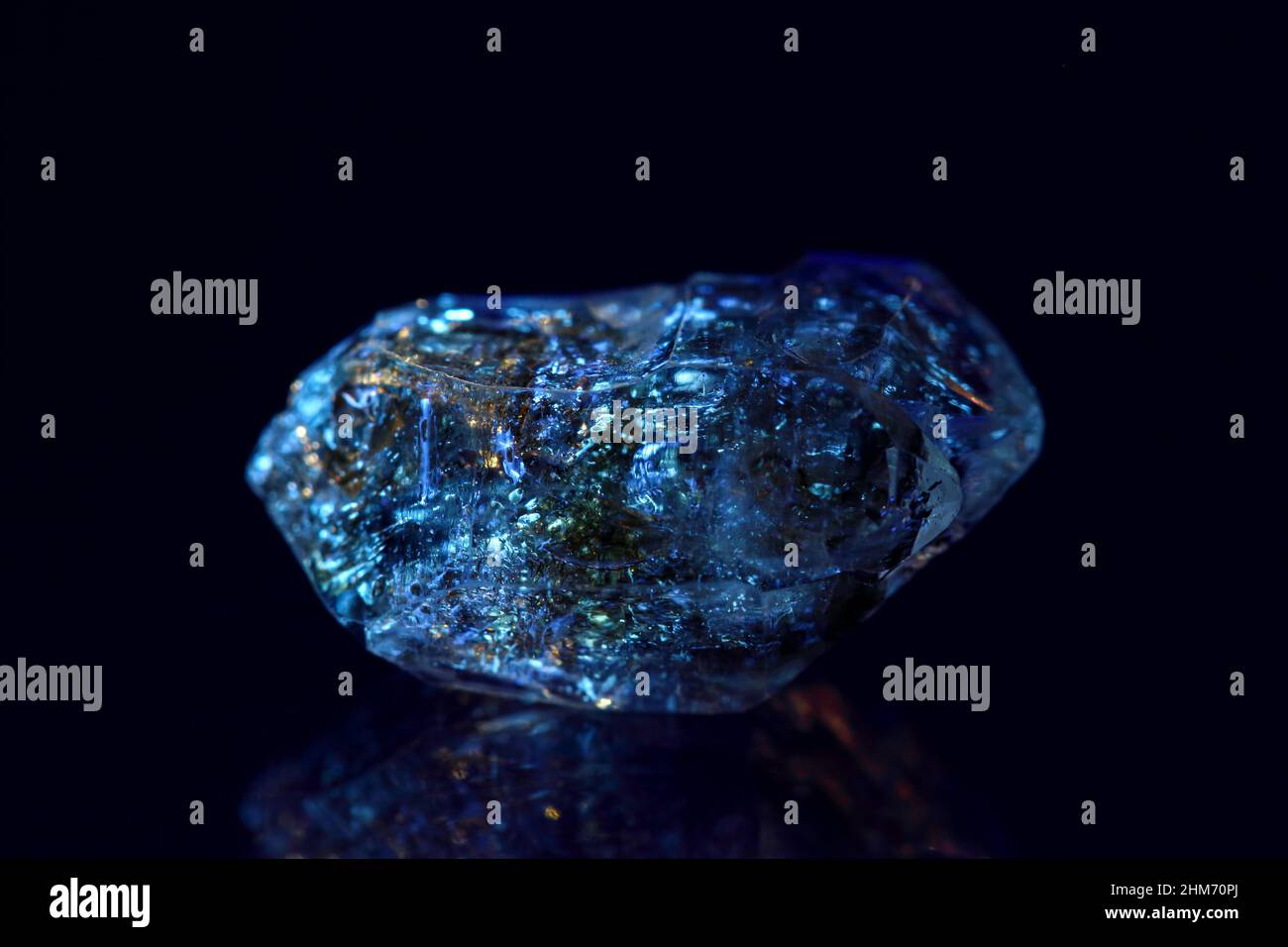 Rare variety of diamond quartz with hydrocarbon inclusions (Petroleum quartz / Enhydro or EnPetro Quartz) show fluorescence glowing under UV light Stock Photo