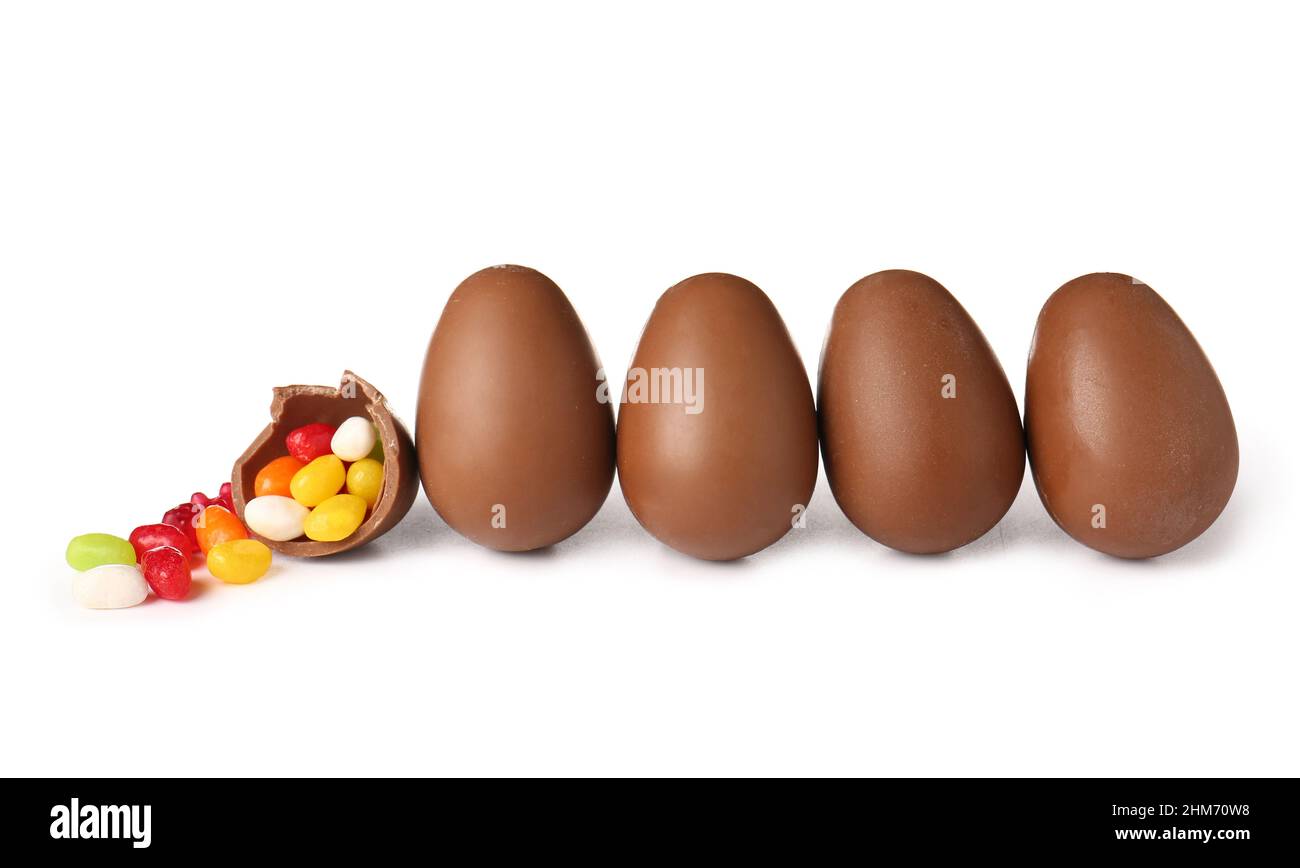 Delicious chocolate Easter eggs and different candies on white background Stock Photo