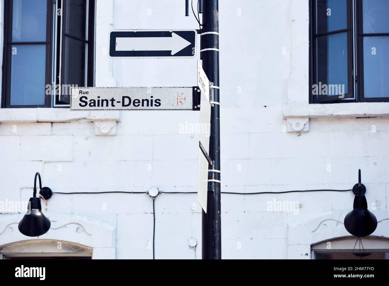 The sign post of rue Saint Denis street in Montreal Quebec Canada. Saint-denis street is a tourist attraction center known as the heart of Montreal. Stock Photo