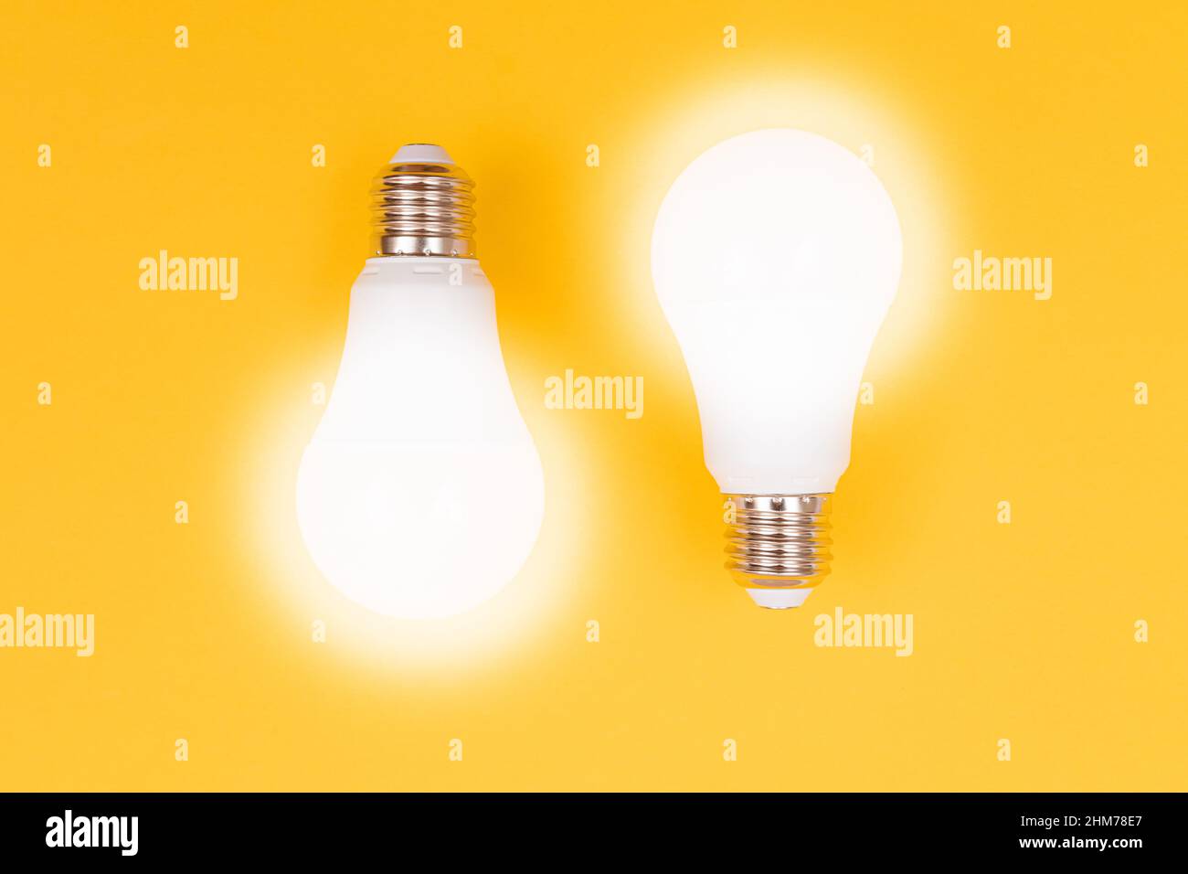 A Power Saving Lamps on Yellow Background - Top View Stock Photo
