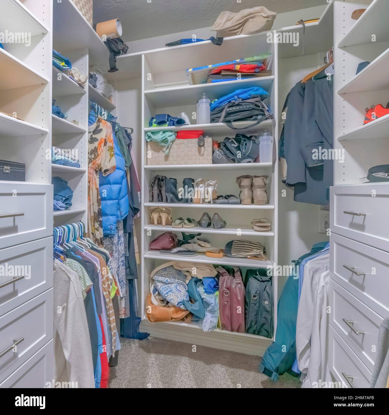 Square Walk in closet interior with white wooden shelving units Stock Photo  - Alamy