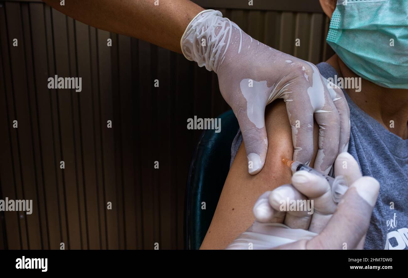 Old Practice Injection General practitioner vaccinating old patient in clinic with copy space ...