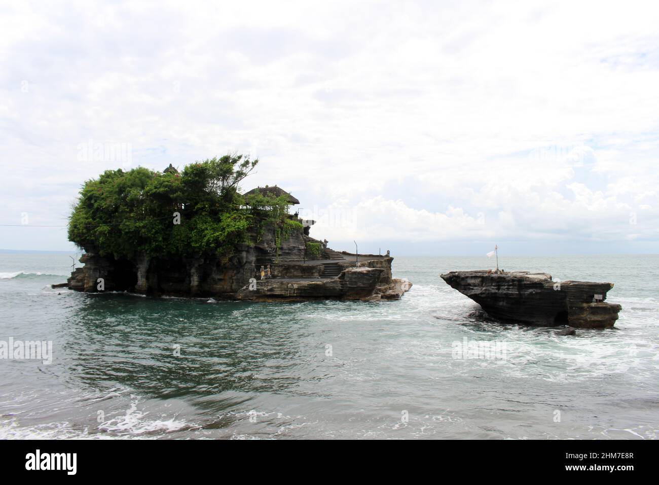 A closer view of Tanah Lot, a Balinese Hindu temple on top of cliff and ...