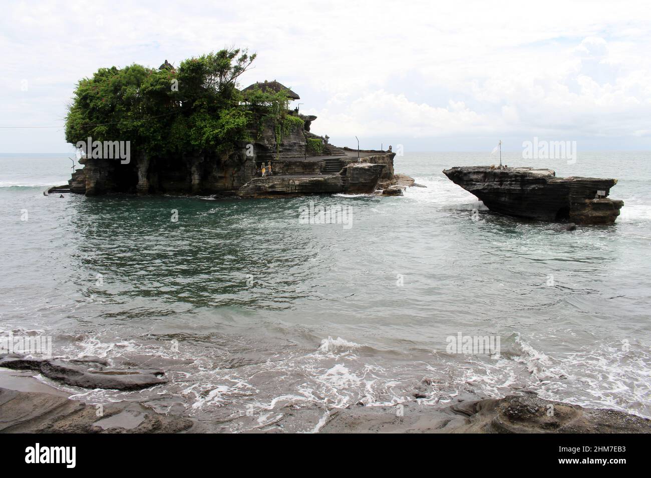 A closer view of Tanah Lot, a Balinese Hindu temple on top of cliff and ...