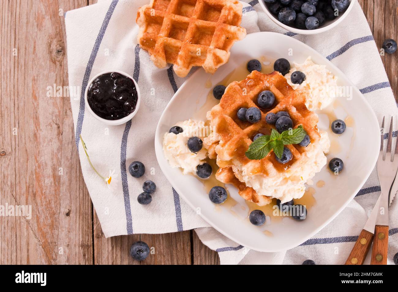 Waffles with blueberries and whipped cream Stock Photo - Alamy