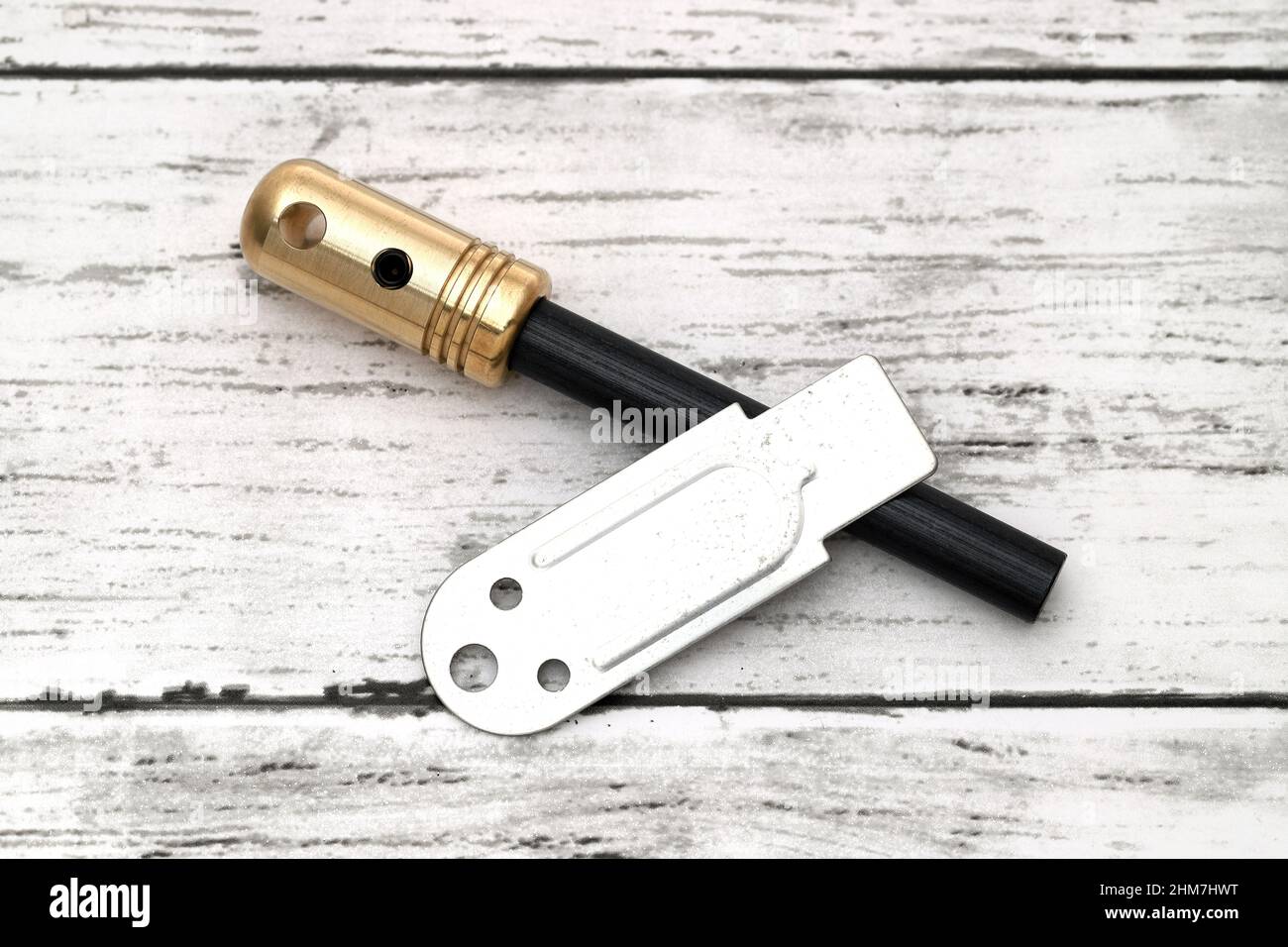 Fire starter, camping equipment on white wooden background Stock Photo
